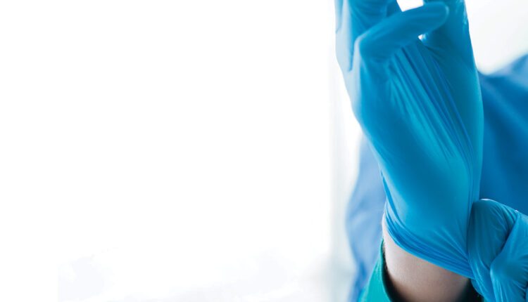 Clinician putting on a glove