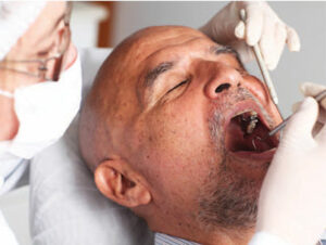 Older adult receiving oral cancer screening 