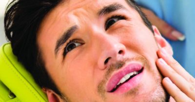 Man in pain in dental chair
