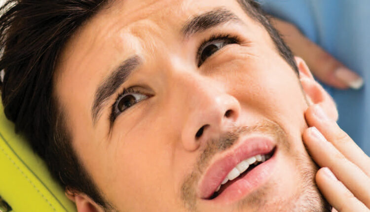 Man in pain in dental chair