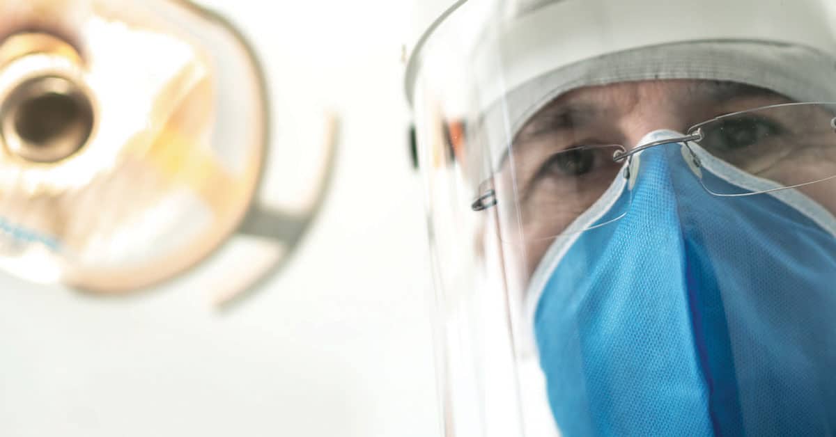 Clinician wearing PPE to prevent COVID-19 transmission