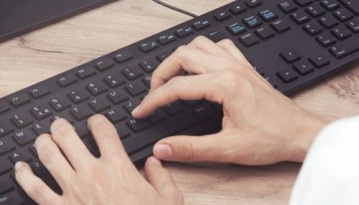 Hand typing on keyboard