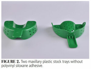 FIGURE 2. Two maxillary plastic stock trays without polyvinyl siloxane adhesive.