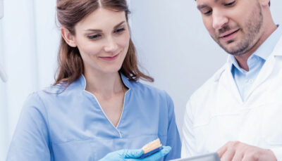 dental professionals looking at tablet