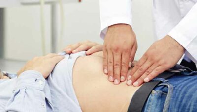 doctor examining a patient's stomach