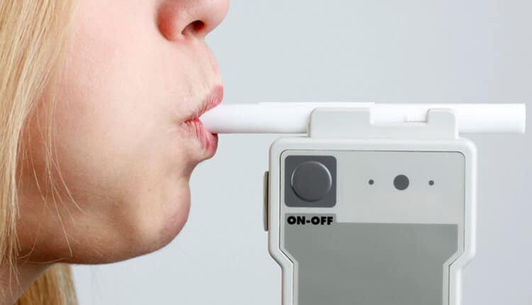 Woman Blowing in Breathalyzer
