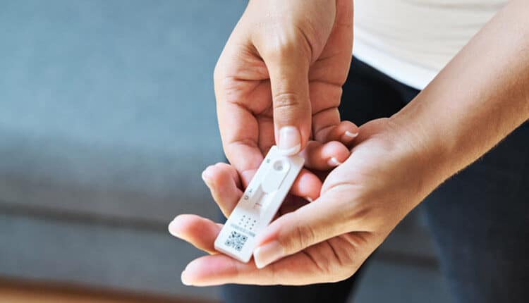 Woman taking a Covid-19 rapid antigen test at home.