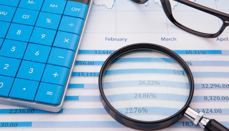 Calculator, pen and business balance