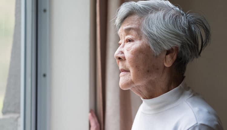 elderly woman look out of the window