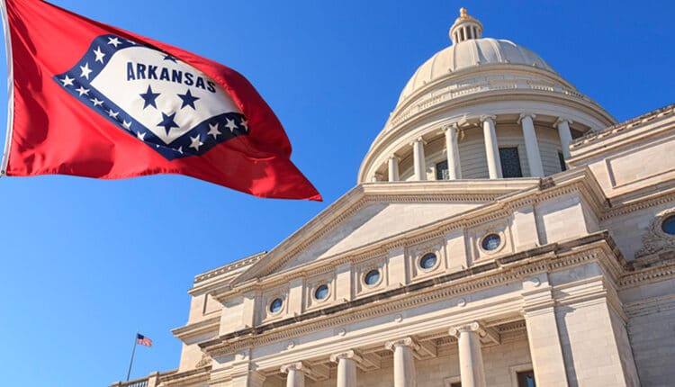 Arkansas flag flying high beside the State Capitol Building