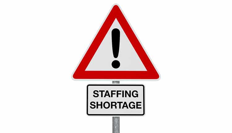 Caution Coronavirus - STAFFING SHORTAGE - digitally generated image