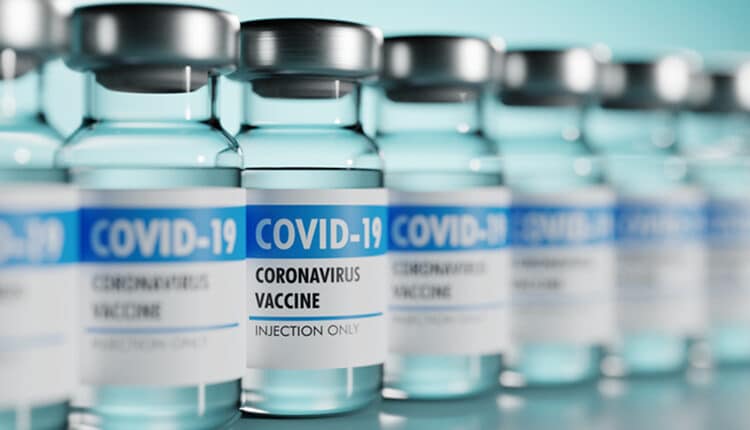Row of Coronavirus vaccine flasks. Shallow depth of field.