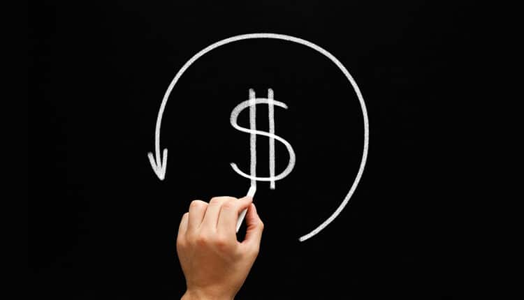 dollar sign in arrow circle with chalk on blackboard