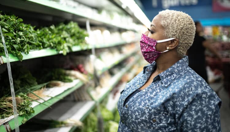 Woman with face mask shopping at supermarket