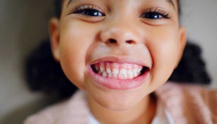 Close-up of a smiling girl showing her teeth